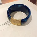 Macro view of navy blue acrylic bangle with gold multi-strand metal chain detail - Geometric Open Style (21#)