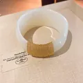 Close-up of white acrylic bangle with elegant gold chain wrap detail and smooth finish - Geometric Open Style (24#)