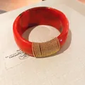 Close-up detail of a red gradient acrylic bangle featuring elegant gold chain wrap accents - Geometric Open Style (19#)