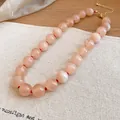 Close-up of pink translucent acrylic beaded necklace with red knots on linen background. - Peach Pink (74#)