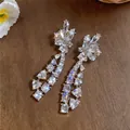 Close-up of elegant long dangling earrings with sparkling clear marquise and teardrop crystals - Stud Earrings (925 Silver Pin) / Silver-White