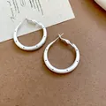 Close-up of silver brushed hoop earrings with minimalist black polka dot design - 4cm / 69# Black Polka Dot Style (69#) / Silver