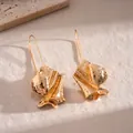 Detailed view of elegant gold irregular textured leaf earrings on a stone surface - Irregular Wrinkle Ear Hooks / Gold