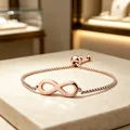 Detailed view of a rose gold infinity symbol bracelet featuring an adjustable box chain - Square Pearl Chain / Rose Gold