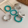 Macro view of turquoise bead bracelets and silver-colored open cuff jewelry set - 6-Piece Set / 60# Bangle Silver Sea Blue
