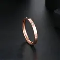 Close-up of a elegant rose gold stainless steel ring featuring embedded clear zircon stones - Size 5 / 2.5mm Six-Diamond Style / Rose Gold