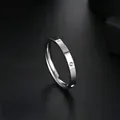 Detailed macro view of a sleek stainless steel ring featuring micro-paved cubic zirconia accents - Size 5 / 2.5mm Six-Diamond Style / Silver