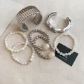 Detailed group shot of a French style silver cuff and beaded bracelet jewelry set - 7-piece Set / 70# Bangle Silver White Glass