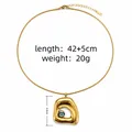 Gold evil eye necklace featuring an irregular geometric hollow pendant and snake chain - Hollow Geometric Eye Pendant Style