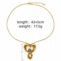 Gold heart pendant necklace with green evil eye detail and 42+5cm adjustable chain - Twisted Heart Green Eye Style