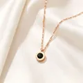Macro detail of rose gold Roman numeral necklace with black crystal pendant on silk - Rose Gold Black