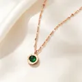 Detail of rose gold necklace featuring a green crystal pendant with Roman numerals. - Rose Gold Green
