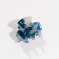 Close-up detail of a small acetate hair claw clip with blue and green marble pattern - Navy Green
