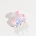 Close-up view of a small pastel marble acetate hair claw clip for half-up hair styles - Blue Pink