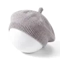 Detailed macro view of a soft grey knitted baby beret hat for infants on white display - Gray