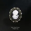 Vintage gold-tone cameo brooch with white profile silhouette and sparkling rhinestones - Brown-Red Base White Image Style (XD7383-3)