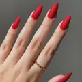 Sophisticated long almond shaped matte red press-on nails showcased on a hand - Almond Shape / Matte Red (CDJ-8-500#1)