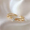 Elegant gold-plated adjustable ring with blue zircon flower on silk background. - Adjustable Open / Light Blue Flower (JZ063)
