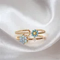 Elegant adjustable gold-plated ring featuring delicate light blue and yellow floral motifs - Adjustable Open / Blue Zirconia Daisy (JZ036)