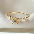 Elegant gold adjustable ring with blue zircon bow charm and clear accents for women - Adjustable Open / Blue Bow Pendant (JZ042)