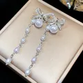 Elegant silver-toned bow and pearl tassel dangle earrings with sparkling zirconia accents - 2 Silver Post (Long Tassel Artificial Pearl) / Silver