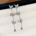 Silver dangling earrings featuring three tiered zirconia bows in a luxury minimalist style - 40 Silver Post (Triple Bowknot Tassel-Silver) / Silver