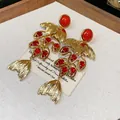 Luxury gold plated dangle earrings featuring red stones and a unique fish tail design - 33 Silver Post (Fan Fishtail Red Zirconia) / Gold-Red