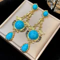 Vintage gold-plated dangle earrings with turquoise stones and ornate artistic design - 61 Silver Post (Bohemian Turquoise Pendant) / Gold-Blue