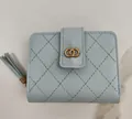 Elegant light blue quilted women's short wallet with gold double-ring hardware and tassel - Blue