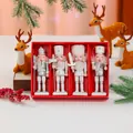 Detailed view of four white and silver nutcracker soldier ornaments in a festive red box - Silver and White Nutcracker 4-Piece Set