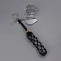 Close-up of handmade black woven pouch keychain with a silver heart locket charm - Woven Style with Heart Mirror / Black