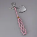 Close-up view of pink handmade woven mesh lipstick holder featuring a silver heart mirror - Woven Style with Heart Mirror / Pink