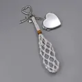 Detail of hand-woven white net pocket with silver heart locket mirror charm - Woven Style with Heart Mirror / White