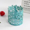 Close-up detail of a teal laser-cut paper lampshade with delicate hollow floral patterns - Lake Blue