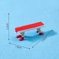 Miniature red Christmas bench with Santa boot legs, size 5.8 x 1.5 x 2.2 cm for decor. - Long Bench (C0518) / 1 Piece