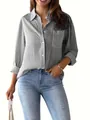 Close-up of a women's black and white vertical striped casual long-sleeve button-down shirt - S / Tops / Black
