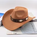 Detail of classic brown cowboy hat with bull head emblem on magazine background. - Beaded Cowboy Style / Deep Beige