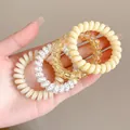 Lot de divers élastiques à cheveux en spirale colorés tenus en main pour la coiffure - Style 4 / 4件套 5.5cm / Jaune