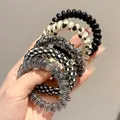 Lot de cinq élastiques à cheveux spirale aux motifs variés, fleurs et damiers inclus - Style 5 / 5件套 5.5cm / Noir