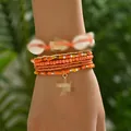 Detalle de conjunto de 7 pulseras bohemias de cuentas con concha y colgante de estrella - Juego de 7 piezas / Naranja