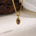 Close-up showing the intricate detail of a gold necklace with a purple marquise zircon - Purple Zircon (Gold)