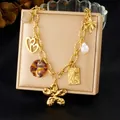 Detail view of vintage gold-plated necklace with diverse charms like heart and star - Thick Chain Multiple Pendants (N3884)