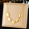 Close-up detail showing the gold-plated stainless steel necklace with five heart pendants - Paperclip Heart Vintage Gold (N3657)