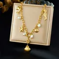 Vintage gold-plated stainless steel necklace with marine charms and pearls on display - Dolphin Seahorse Starfish Style (N3570)