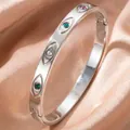 Silver-colored evil eye bangle with colorful cubic zirconia on pink satin background - Evil Eye Style (30乙-B-7)
