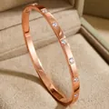 Elegant rose gold titanium steel bangle with sparkling cubic zirconia crystals. - Dotted Rhinestone Style (30-B-9)