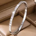 Elegant silver stainless steel bangle with baguette-cut cubic zirconia in jewelry box. - Pave Mirror Style (44-E-1)