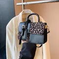 Close-up of retro leopard print patchwork square bag with 'Fashion & Bags' tag. - Leopard Black