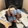 Retro color-block crossbody handbag featuring brown leather and blue denim patchwork. - Brown Blue