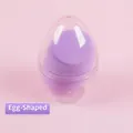 Lila tropfenförmiger Beauty-Blender in einem klaren eiförmigen Kunststoffgehäuse - Wassertropfenform (Box) / Einfarbig Eierschale